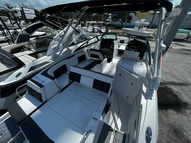 Slide: The Image of 2024 Monterey M-65 boat with spacious seating and modern design at a marina. - 6