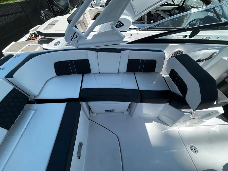 Slide: The Image of 2024 Monterey M-65 boat interior with white and black seating arrangement. - 8