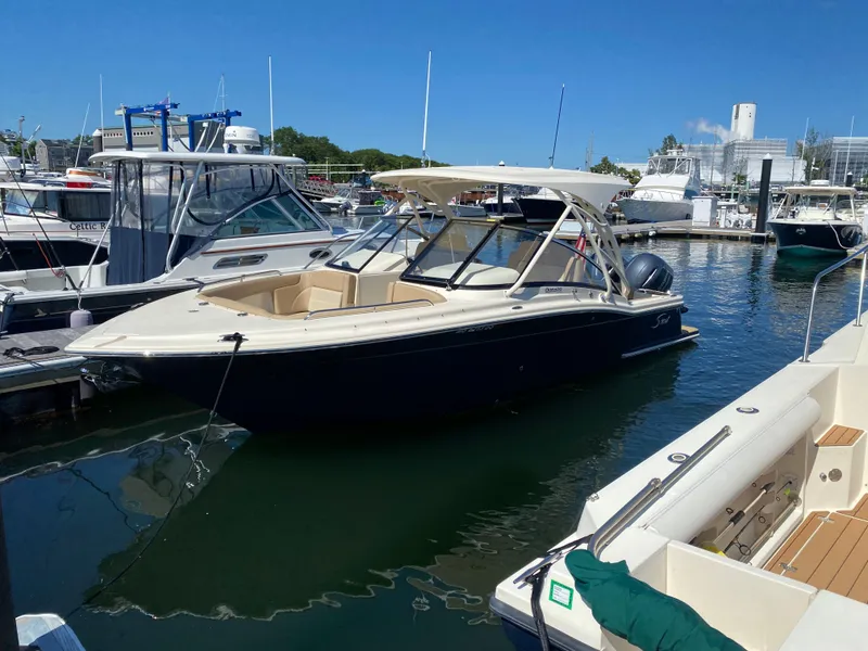 The Image of 2022 Scout 255 Dorado boat docked at a marina on a sunny day. - 0