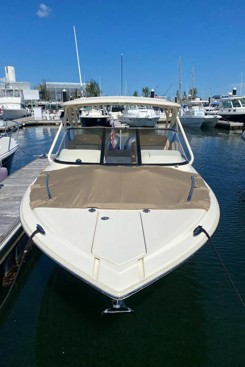 Slide: The Image of 2022 Scout 255 Dorado boat docked at a marina. - 10