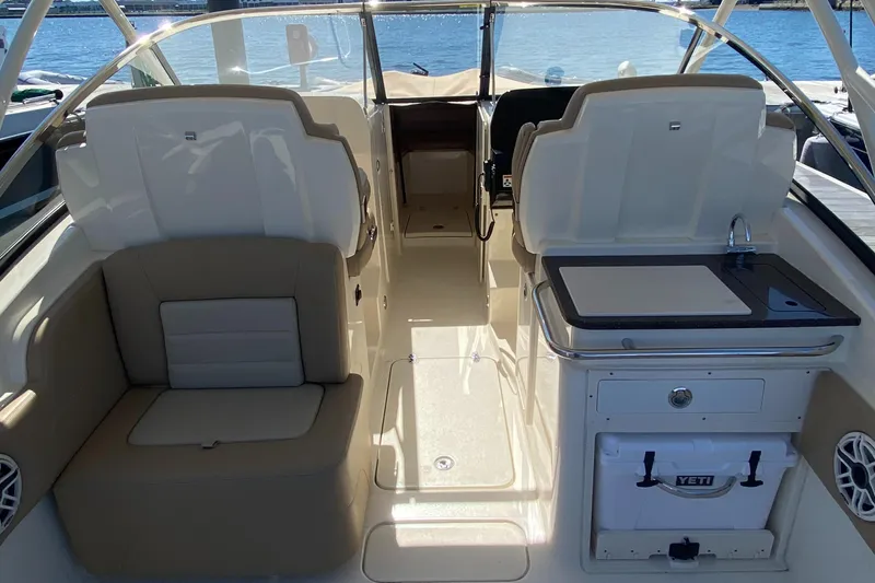 Slide: The Image of 2022 Scout 255 Dorado boat interior with seating and kitchenette. - 17