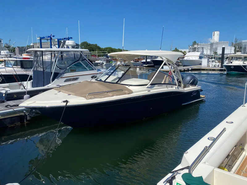 Slide: The Image of 2022 Scout 255 Dorado boat docked at a marina on a sunny day. - 4