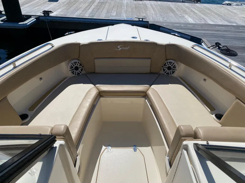 Slide: The Image of 2022 Scout 255 Dorado boat interior with beige seating and speakers. - 7