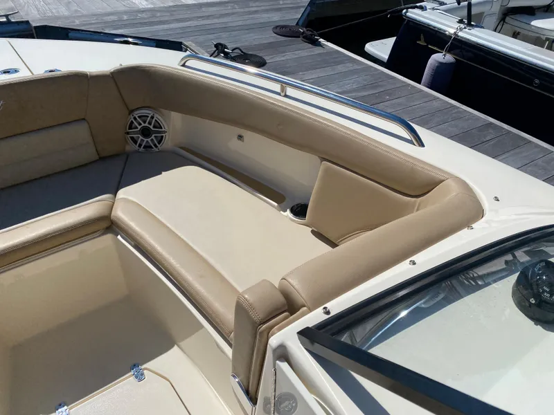 Slide: The Image of 2022 Scout 255 Dorado boat interior with beige seating and speaker. - 8