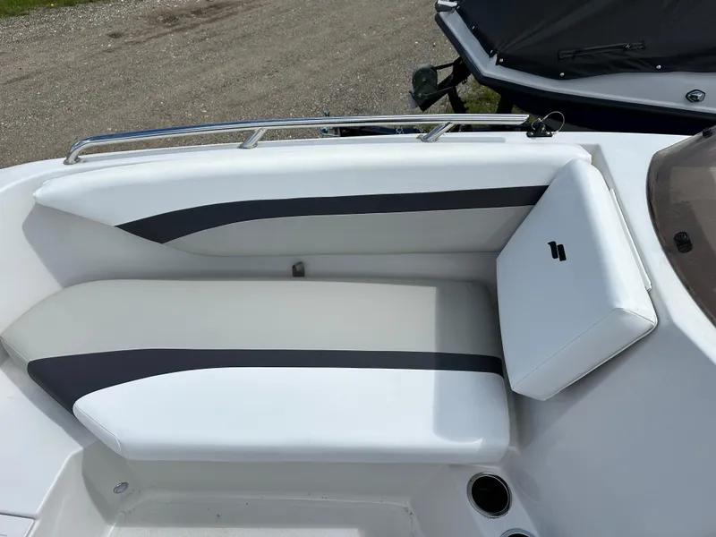 Slide: The Image of 2024 Starcraft SVX171 boat interior with white and gray seating. - 2