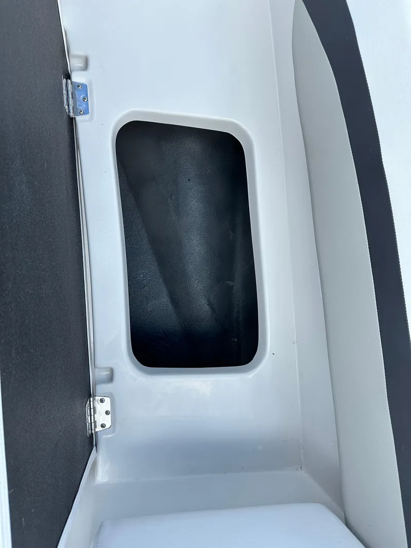 Slide: The Image of 2024 Starcraft SVX171 storage compartment with black interior and white exterior. - 3