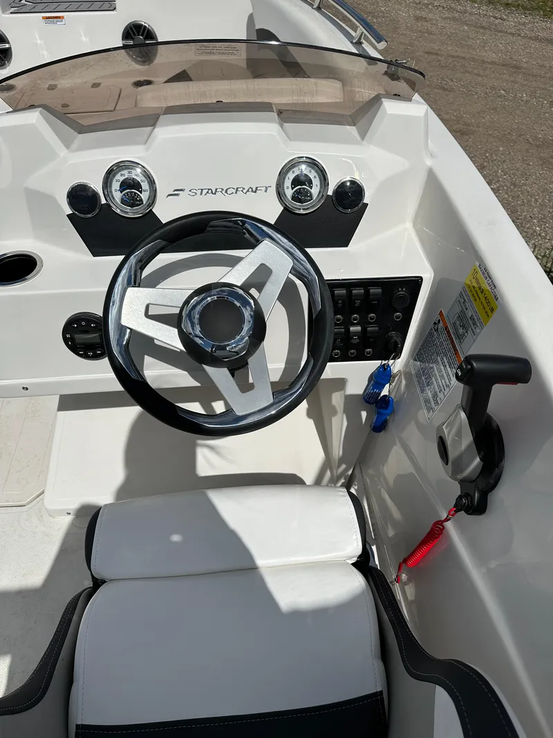 Slide: The Image of 2024 Starcraft SVX171 boat dashboard with steering wheel and control panel. - 6