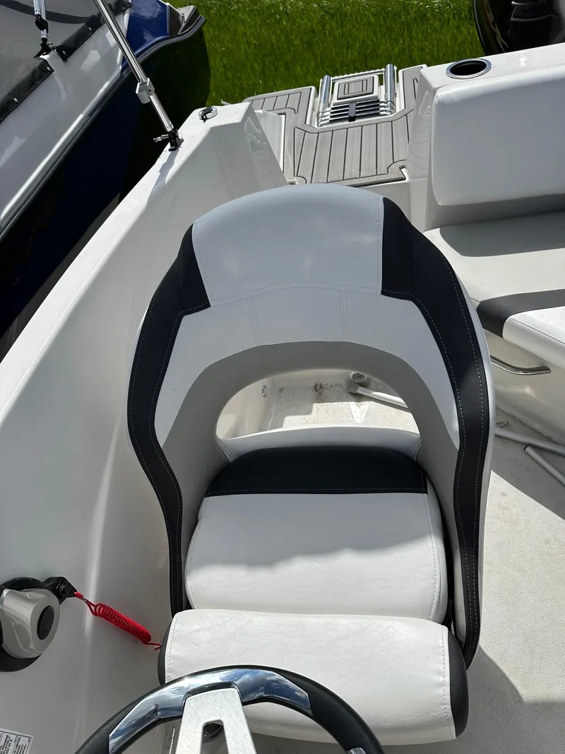 Slide: The Image of 2024 Starcraft SVX171 boat captain's chair and cockpit area. - 7