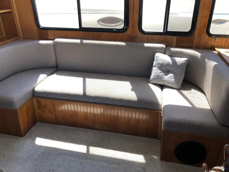 Slide: The Image of 1993 Gibson 37 Sport Series boat interior with cushioned seating and windows. - 11