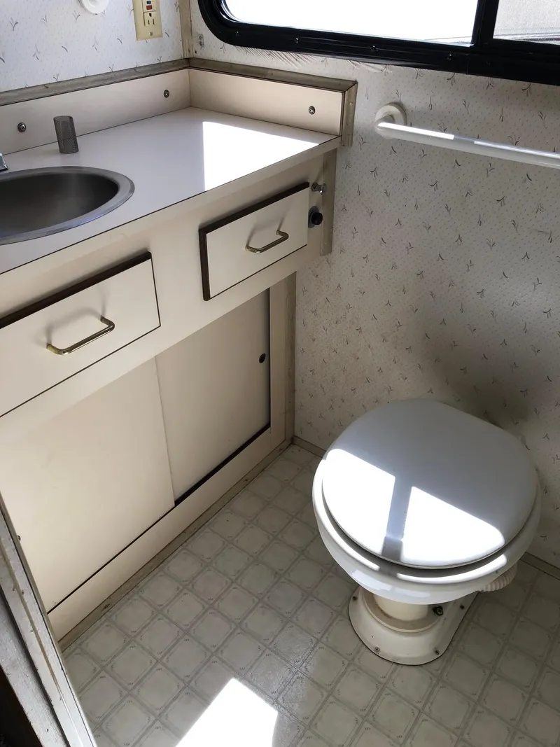 Slide: The Image of 1993 Gibson 37 Sport Series bathroom with sink, vanity, and toilet. - 15