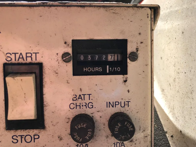 Slide: The Image of Hour meter and control panel of a 1993 Gibson 37 Sport Series boat. - 22