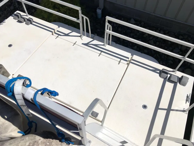 Slide: The Image of 1993 Gibson 37 Sport Series boat deck with white railing and blue ropes. - 4