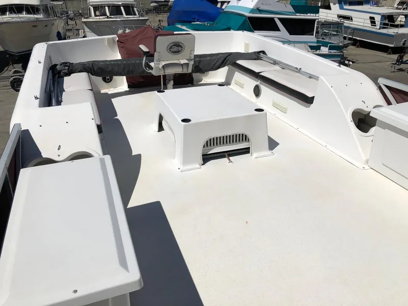 Slide: The Image of 1993 Gibson 37 Sport Series boat deck with seating and storage compartments. - 5