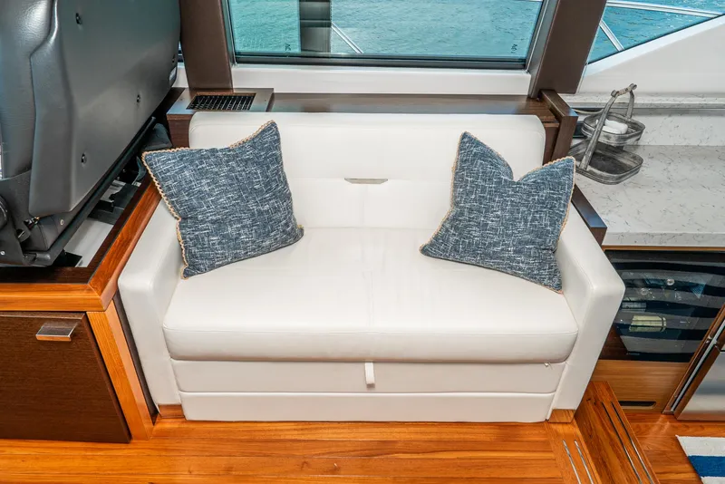 Slide: The Image of Interior of 2017 Tiara Yachts C53 Coupe with white sofa and cushions. - 12