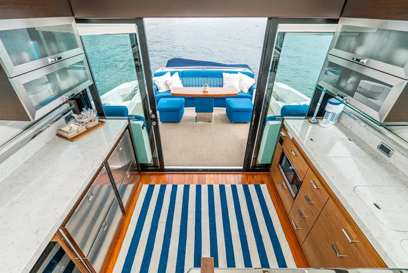 Slide: The Image of Interior of 2017 Tiara Yachts C53 Coupe with modern kitchen and deck. - 16