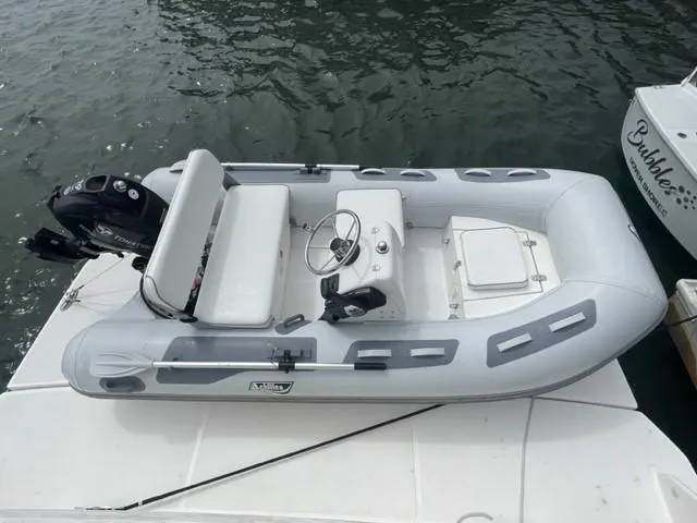 Slide: The Image of Gray inflatable boat on water beside a 2017 Tiara Yachts C53 Coupe. - 48