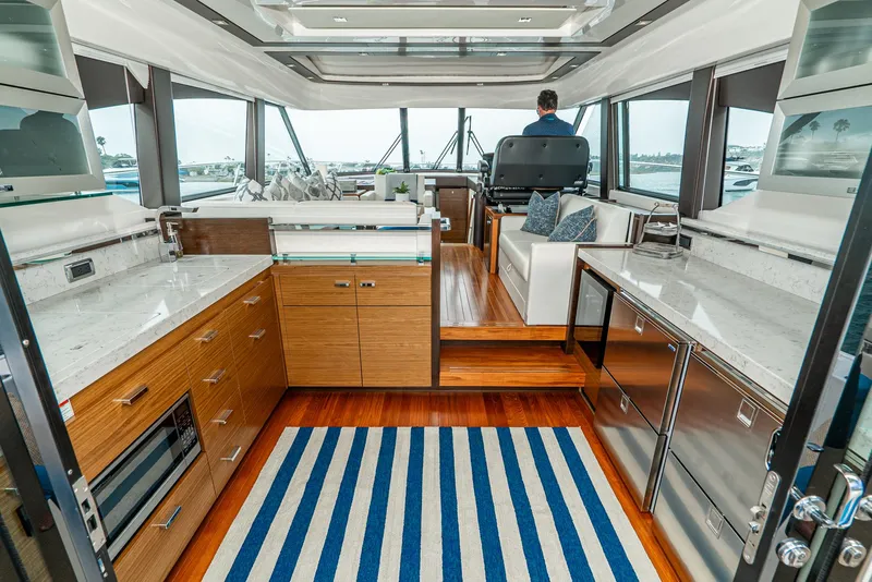 Slide: The Image of Interior of 2017 Tiara Yachts C53 Coupe with modern kitchen and seating area. - 6