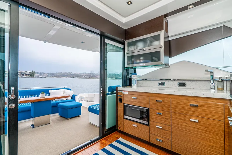Slide: The Image of Interior of 2017 Tiara Yachts C53 Coupe with modern kitchen and ocean view. - 8