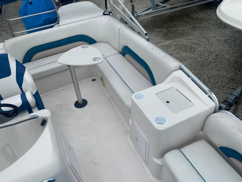 Slide: The Image of Interior of a 2001 Hurricane 198R boat with seating and a small table. - 5