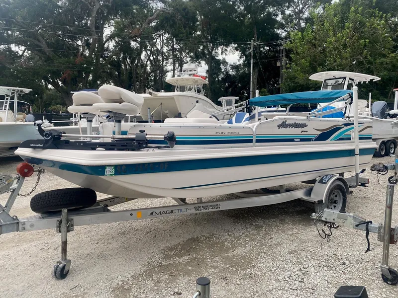 Slide: The Image of 2001 Hurricane 198R Fun Deck boat on trailer in marina. - 7