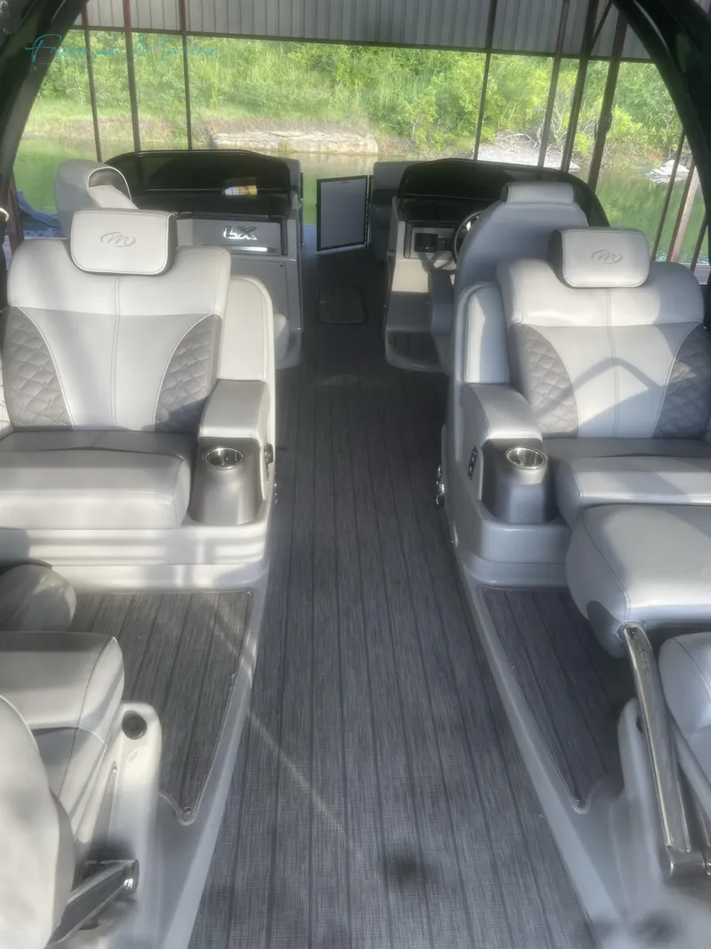 Slide: The Image of 2021 Manitou 27 LX SRW Duel Engine interior with luxurious seating. - 4