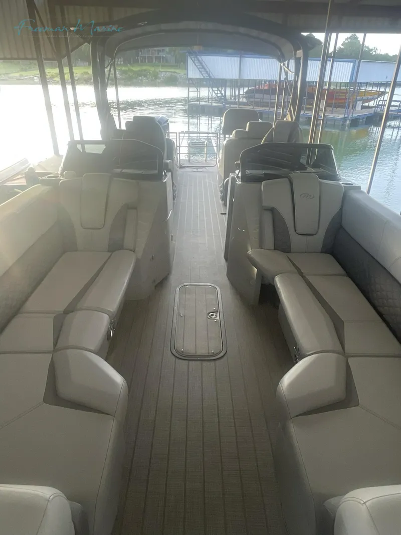 Slide: The Image of 2021 Manitou 27 LX SRW Duel Engine boat interior with spacious seating. - 5