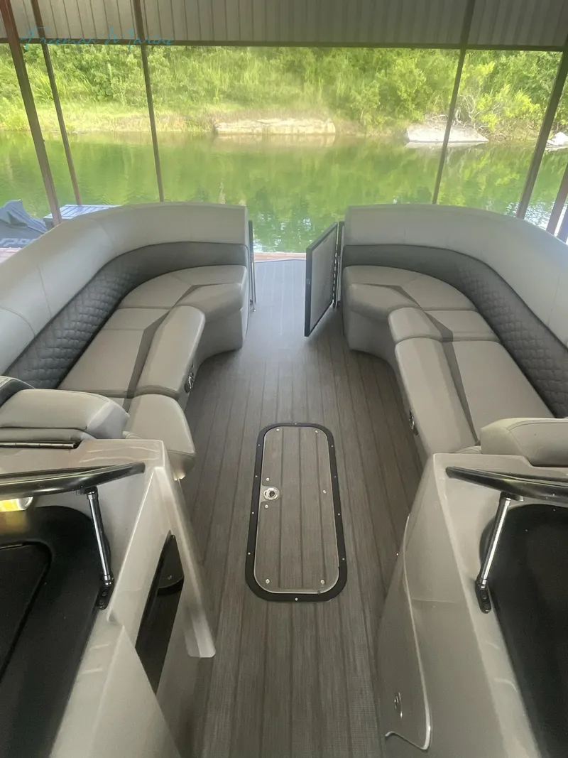 Slide: The Image of 2021 Manitou 27 LX SRW Duel Engine pontoon boat interior with gray seating. - 8