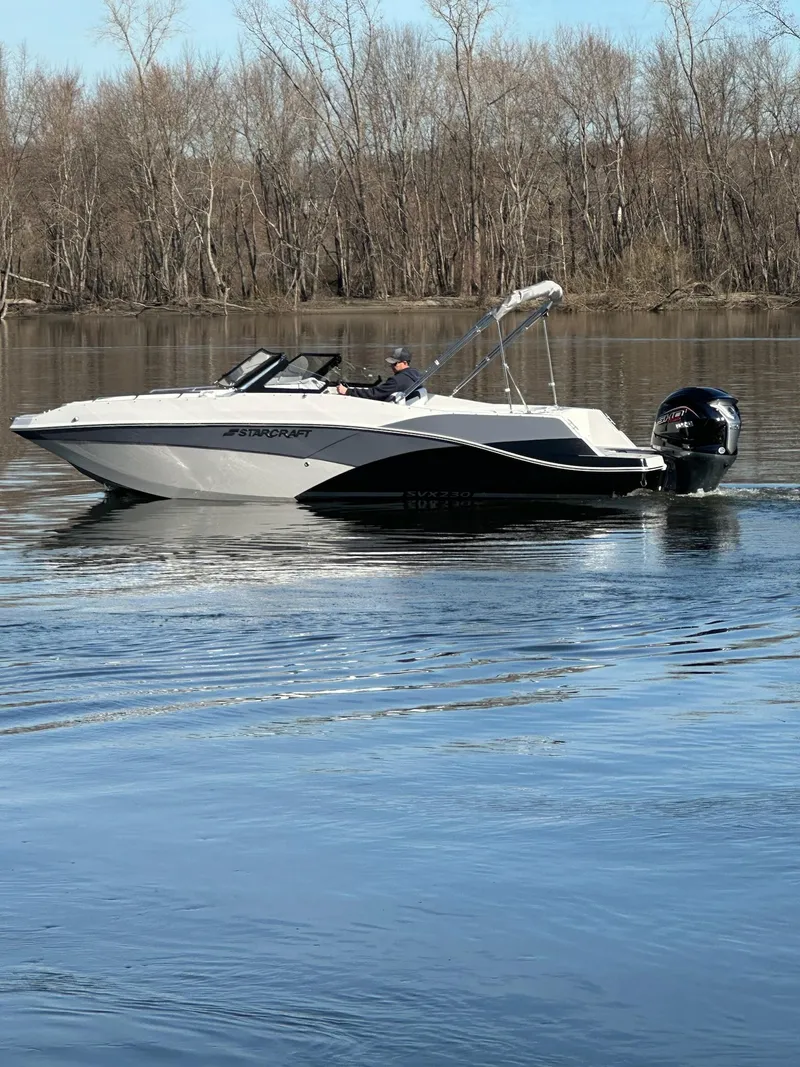The Image of 2024 Starcraft SVX 230 OB boat cruising on a calm lake. - 0