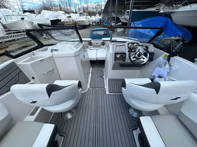 Slide: The Image of 2024 Starcraft SVX 230 OB boat interior with cushioned seating and modern flooring. - 12