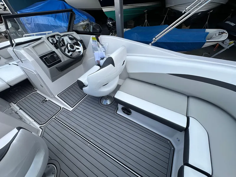 Slide: The Image of 2024 Starcraft SVX 230 OB boat interior with modern seating and steering console. - 13