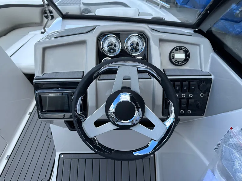 Slide: The Image of 2024 Starcraft SVX 230 OB boat interior with modern helm and seating. - 14