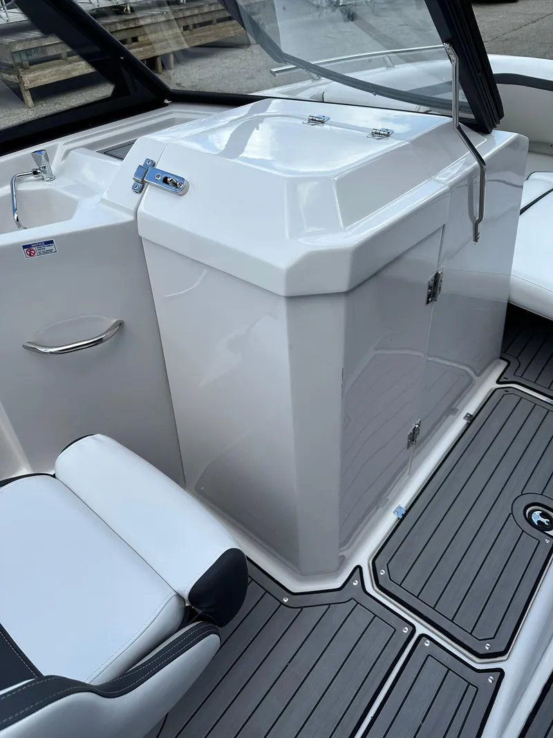 Slide: The Image of 2024 Starcraft SVX 230 OB boat interior with white seating and gray flooring. - 17