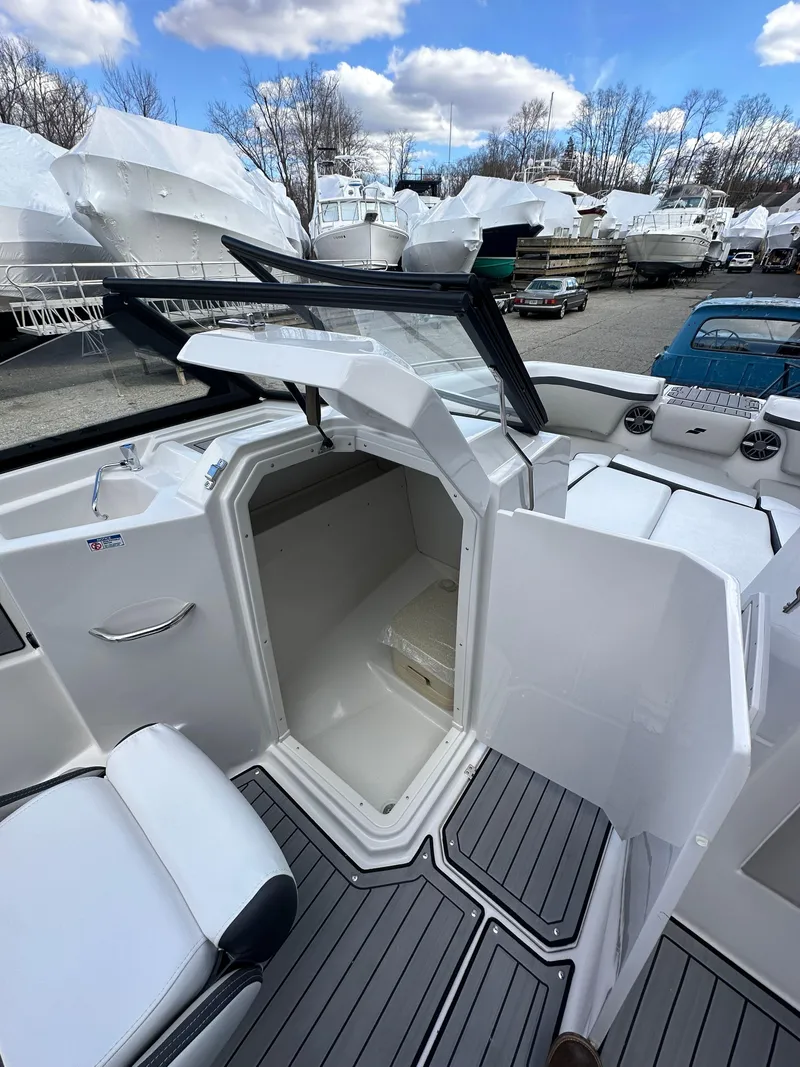 Slide: The Image of 2024 Starcraft SVX 230 OB boat with open storage compartment. - 19