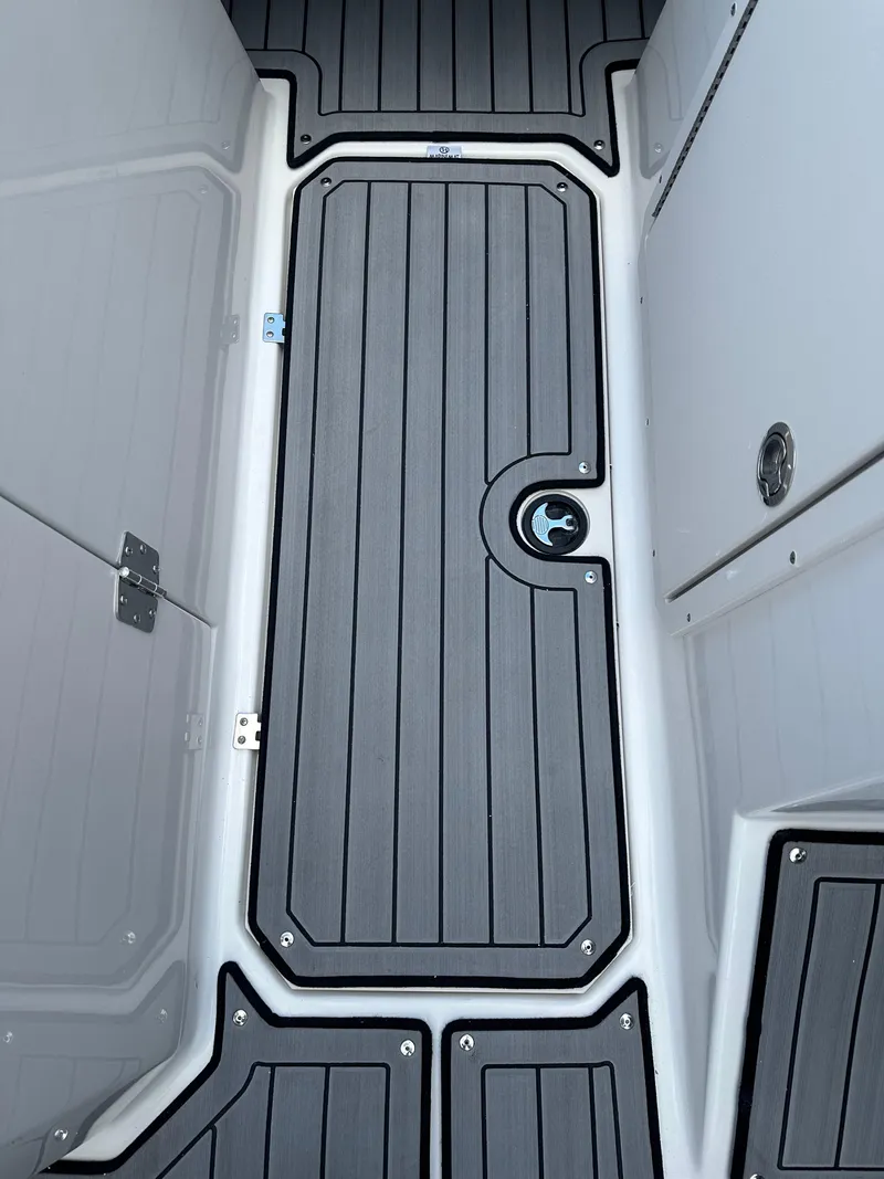 Slide: The Image of 2024 Starcraft SVX 230 OB boat interior with open cabin door and seating. - 20