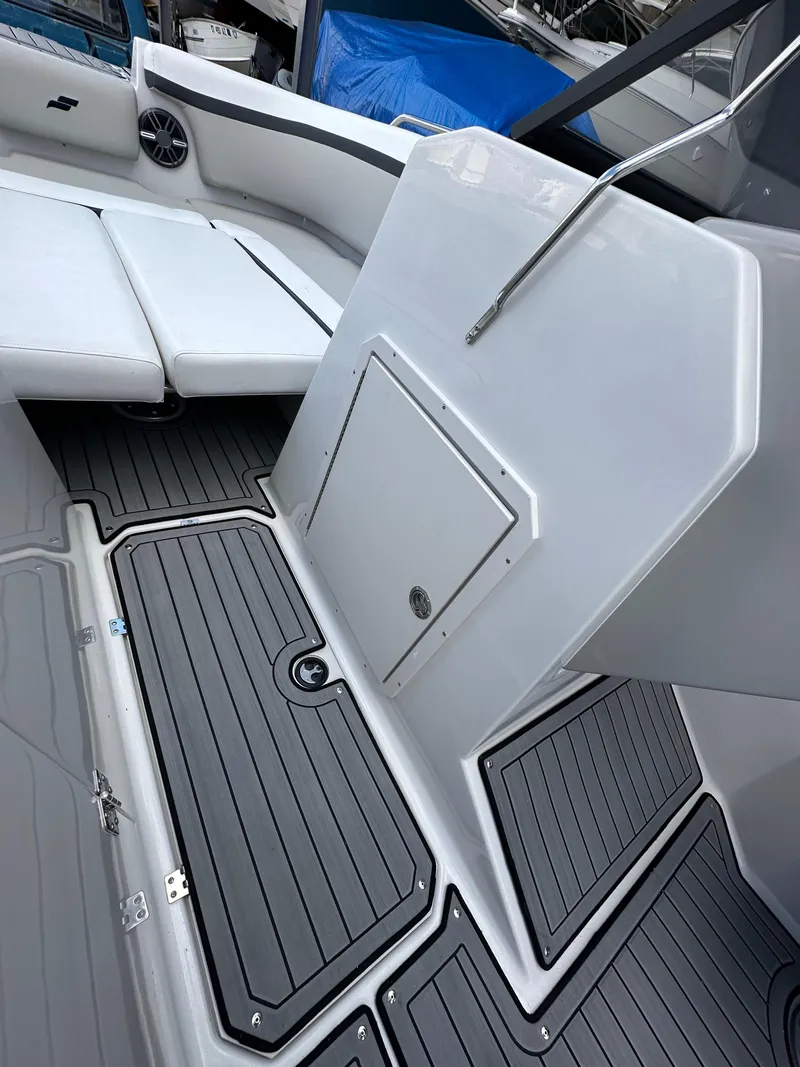 Slide: The Image of 2024 Starcraft SVX 230 OB boat storage compartment with open hatch. - 22