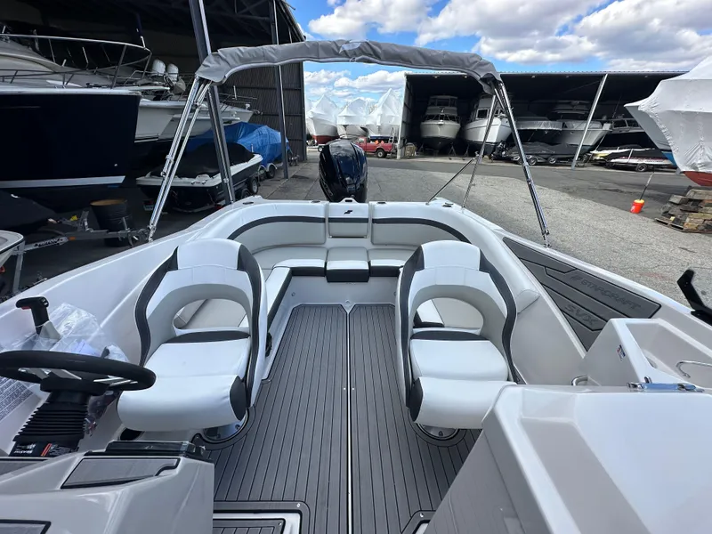 Slide: The Image of 2024 Starcraft SVX 230 OB boat interior with storage compartment and seating. - 29