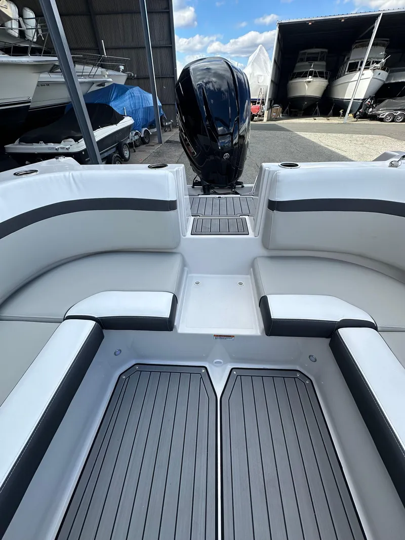 Slide: The Image of 2024 Starcraft SVX 230 OB boat interior with seating and steering wheel. - 30