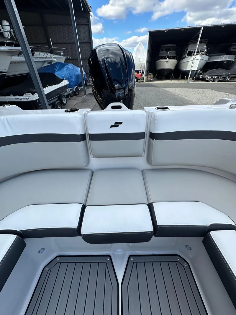 Slide: The Image of 2024 Starcraft SVX 230 OB boat interior with seating and outboard motor. - 31
