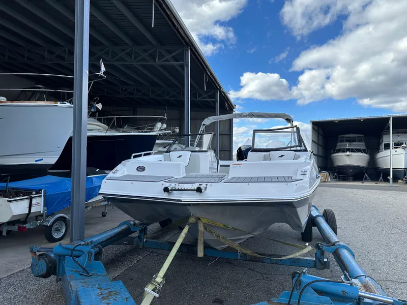 Slide: The Image of 2024 Starcraft SVX 230 OB boat on a blue trailer in a storage facility. - 6