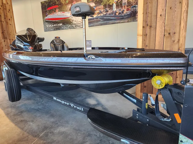 Slide: The Image of 2024 Ranger Z520R fishing boat on trailer in a workshop setting. - 1