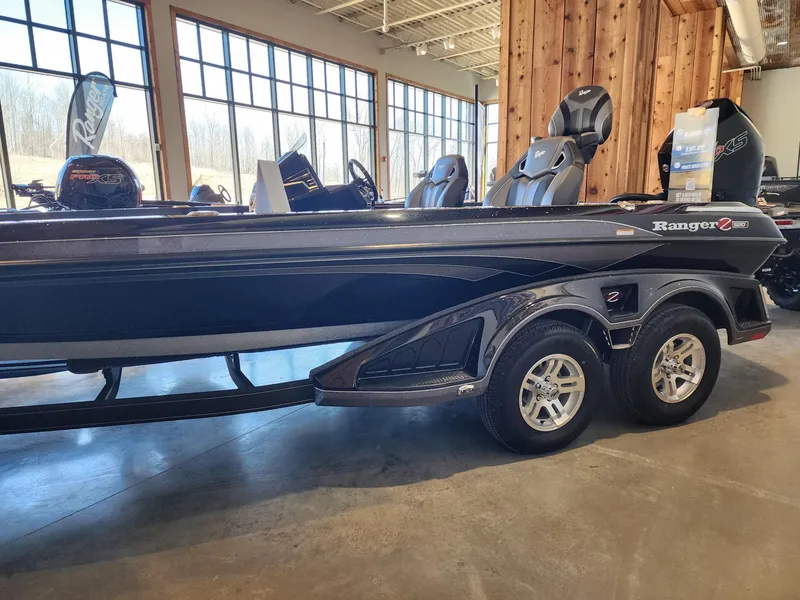 Slide: The Image of 2024 Ranger Z520R boat dashboard with hummingbird logo in a garage setting. - 2