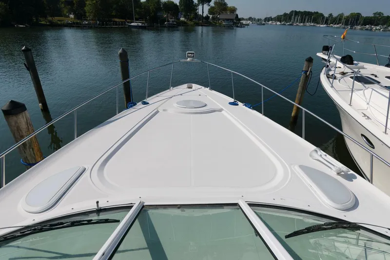 Slide: The Image of 2000 Cruisers Yachts 3672 Express bow view at marina. - 12