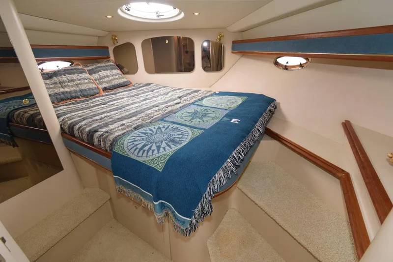 Slide: The Image of Luxurious bedroom in 2000 Cruisers Yachts 3672 Express with cozy bedding and elegant design. - 16