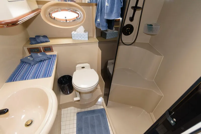 Slide: The Image of Bathroom of 2000 Cruisers Yachts 3672 Express with shower, toilet, sink, and porthole window. - 18