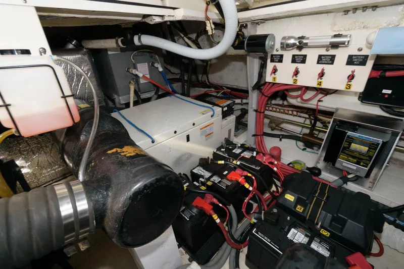 Slide: The Image of Engine room of a 2000 Cruisers Yachts 3672 Express with batteries and wiring. - 22