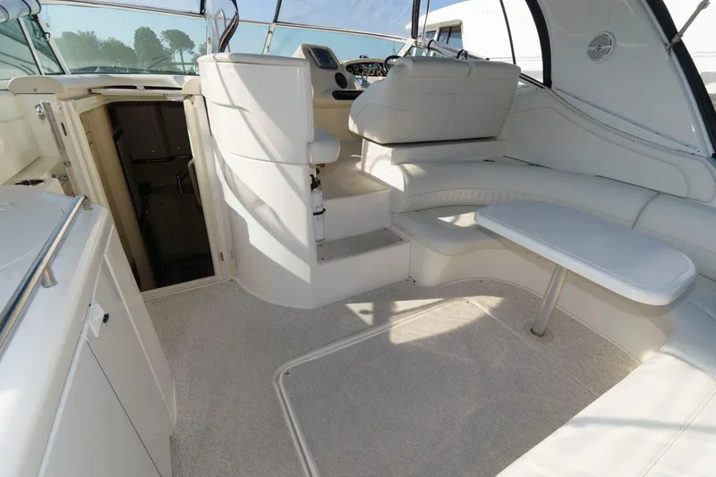 Slide: The Image of Interior of 2000 Cruisers Yachts 3672 Express with white seating and helm station. - 5