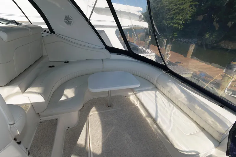 Slide: The Image of 2000 Cruisers Yachts 3672 Express interior seating area with table. - 6