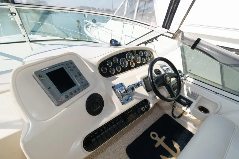 Slide: The Image of Helm of 2000 Cruisers Yachts 3672 Express with navigation equipment and steering wheel. - 9