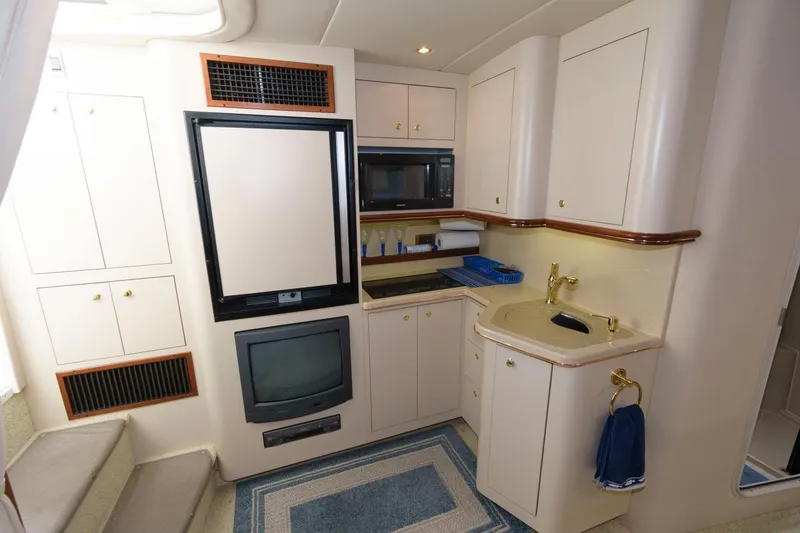 Slide: The Image of 2000 Cruisers Yachts 3672 Express interior kitchen with appliances and sink. - 15