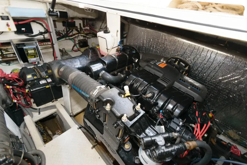 Slide: The Image of Engine compartment of a 2000 Cruisers Yachts 3672 Express with visible wiring and components. - 21